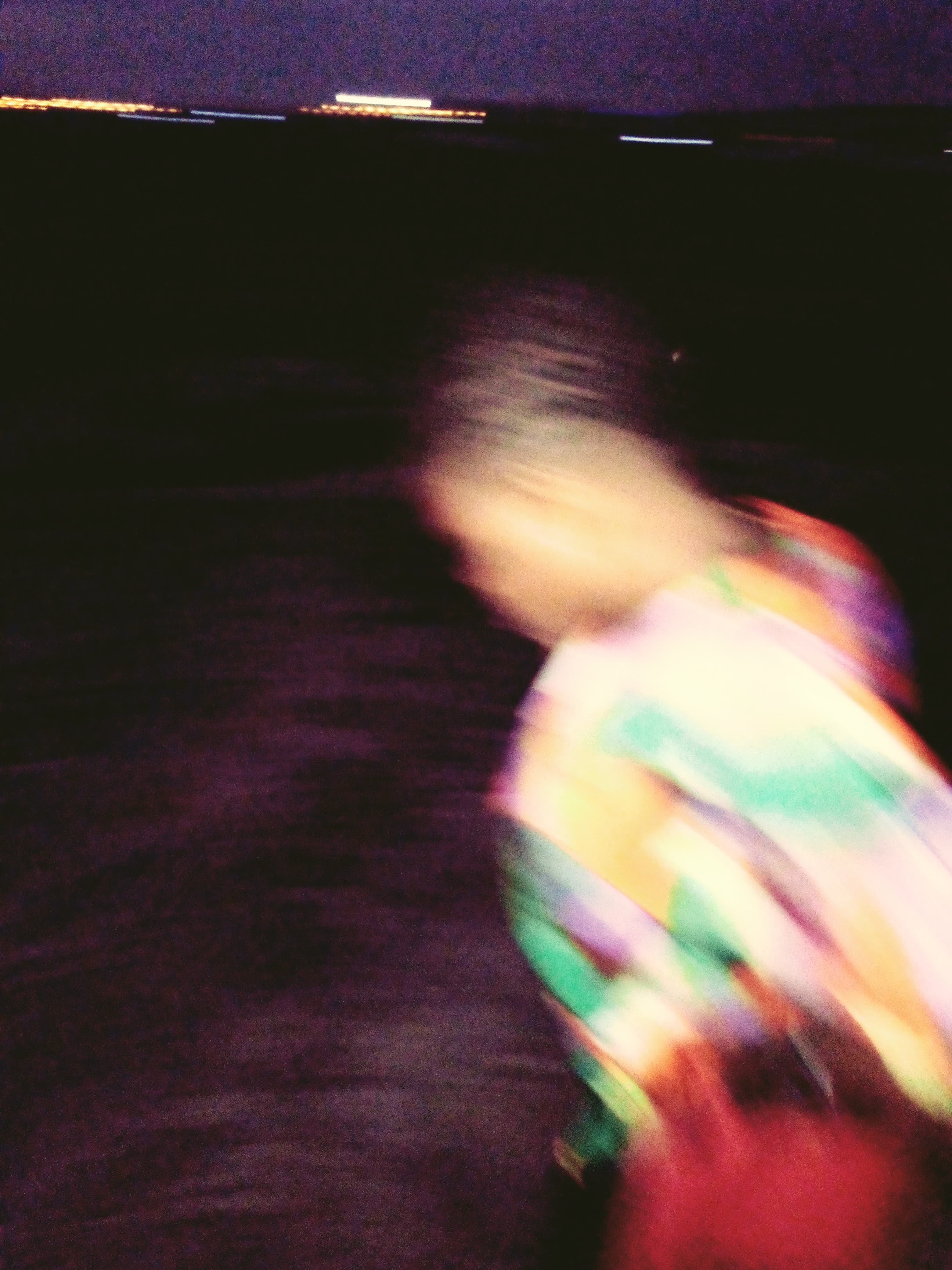 Joan in technicolor — A night by the water, lights on the far shore, Joan moving faster than the shutter. My favourite kind of blur. From the Jedidiah Gabriel (Jedshock) gallery.